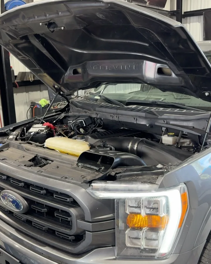 An F-150 engine bay with a Whipple Stage 2 kit installed