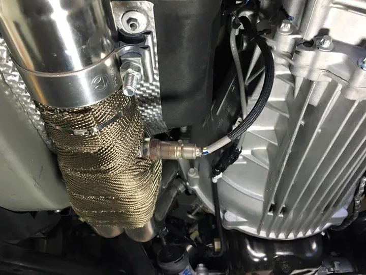 A heat wrapped downpipe running past the bellhousing